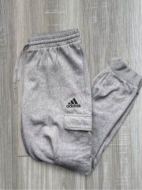 Adidas light gray sweatpants joggers with velcro pockets and stitched logo